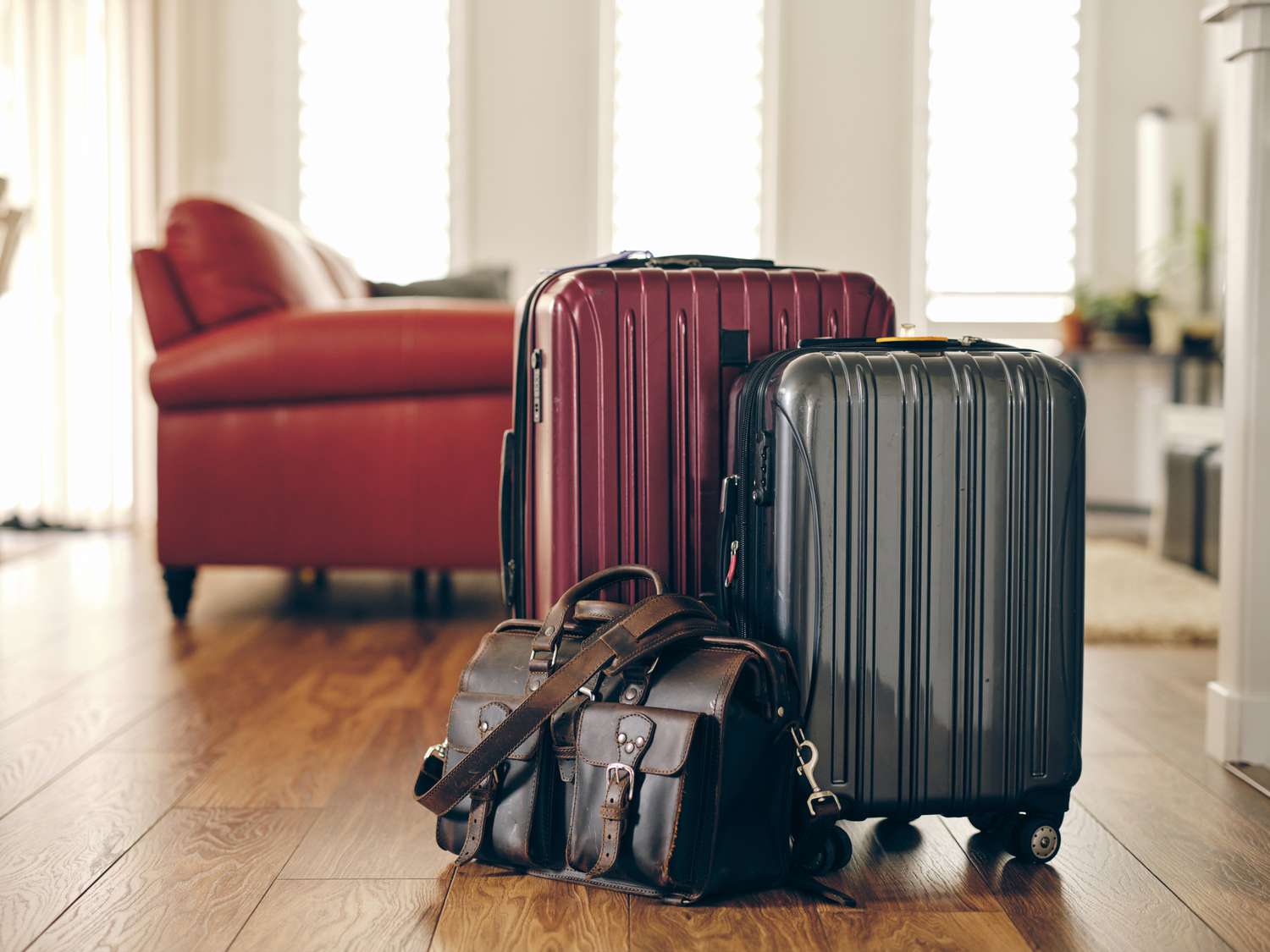 Red, gray, and leather suitcases