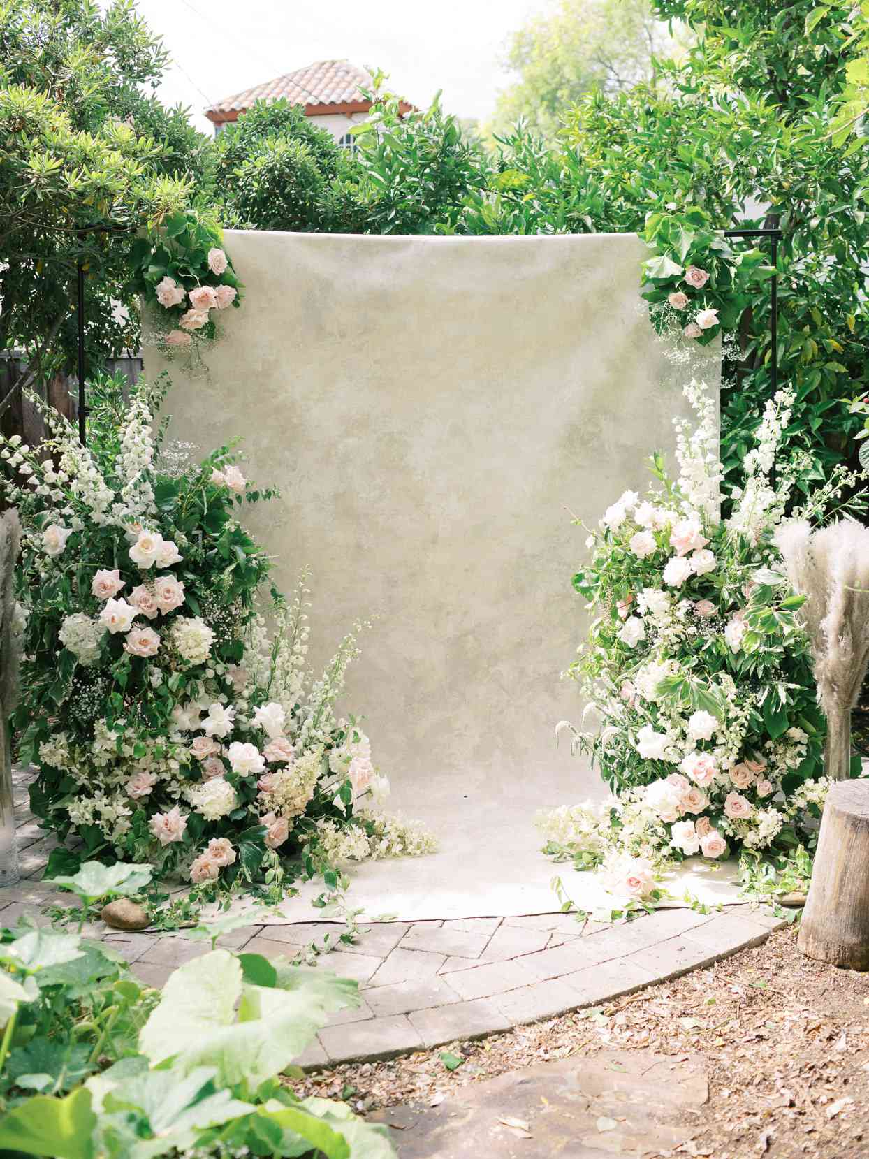 wedding garden ceremony with beige backdrop and florals