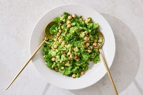 Broccoli and chickpea salad served in a bowl with two spoons