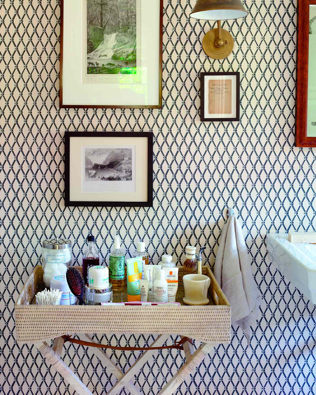 Bathroom with a decorative patterned wall framed artwork and a tray holding toiletries
