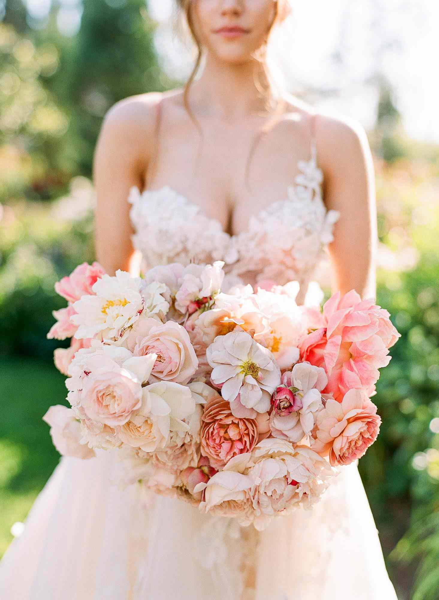 peony bouquets muted pink-and-white peonies, roses, and cosmos to mimic the fluffy dress bodice
