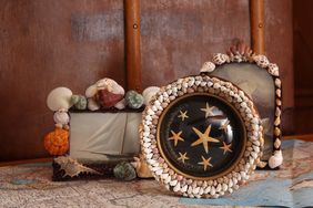 Decorative seashell-framed pictures arranged on a table