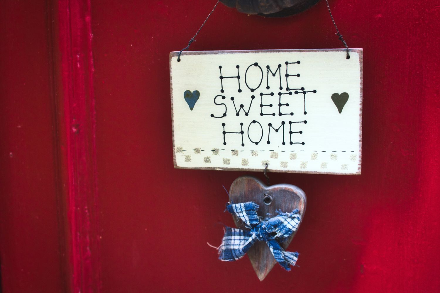 Decorative hanging with Home Sweet Home text and a heartshaped ornament below it