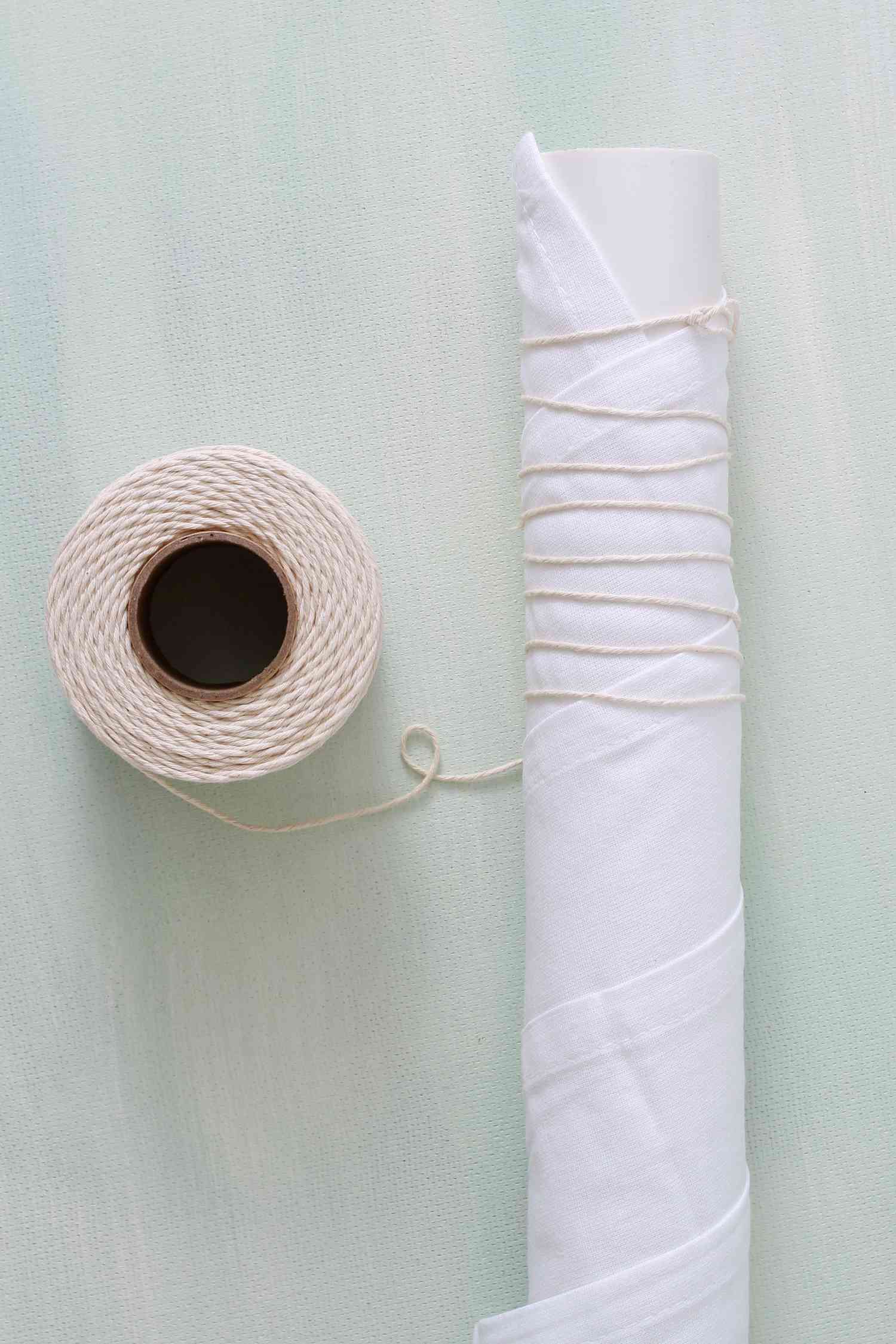 roll of twine with twine wrapped fabric pole