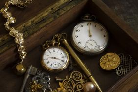 Two old pocket watches inside a box. Still life.