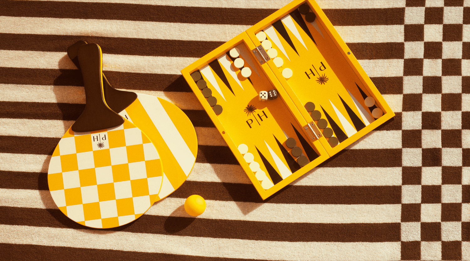 yellow paddle and backgammon set against a striped brown background