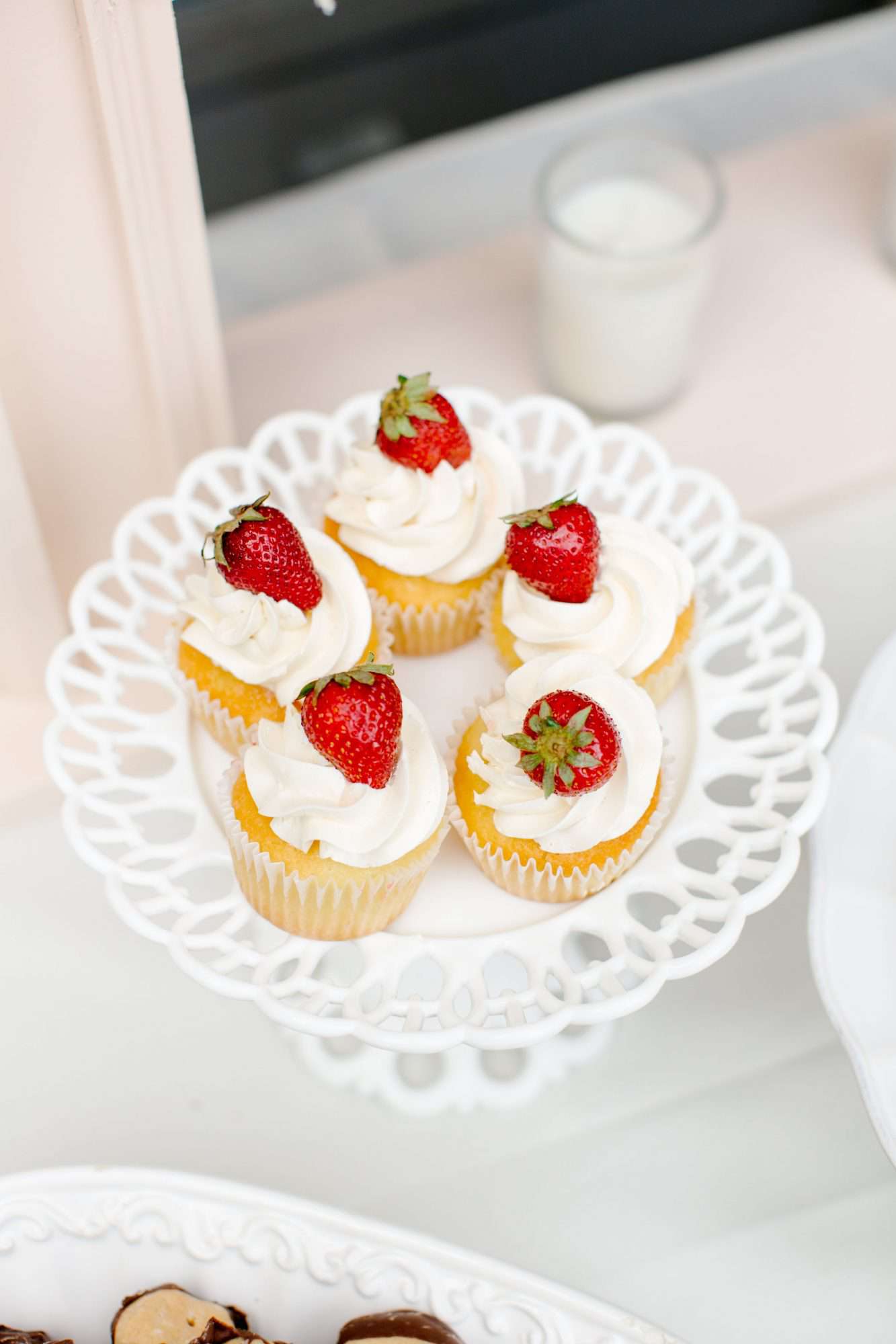 vanilla frosted cupcakes with strawberries