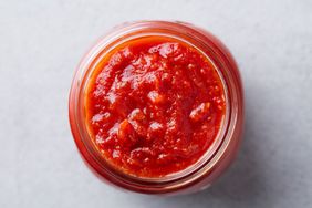 A jar filled with tomato sauce viewed from above