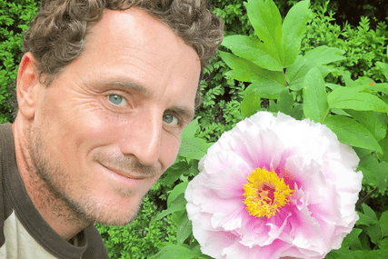 Ryan McCallister next to a peony
