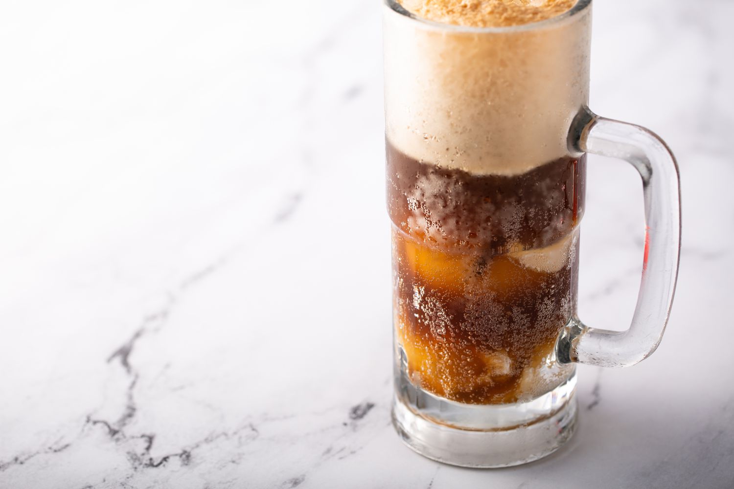 Root beer or soda ice cream float in a large mug