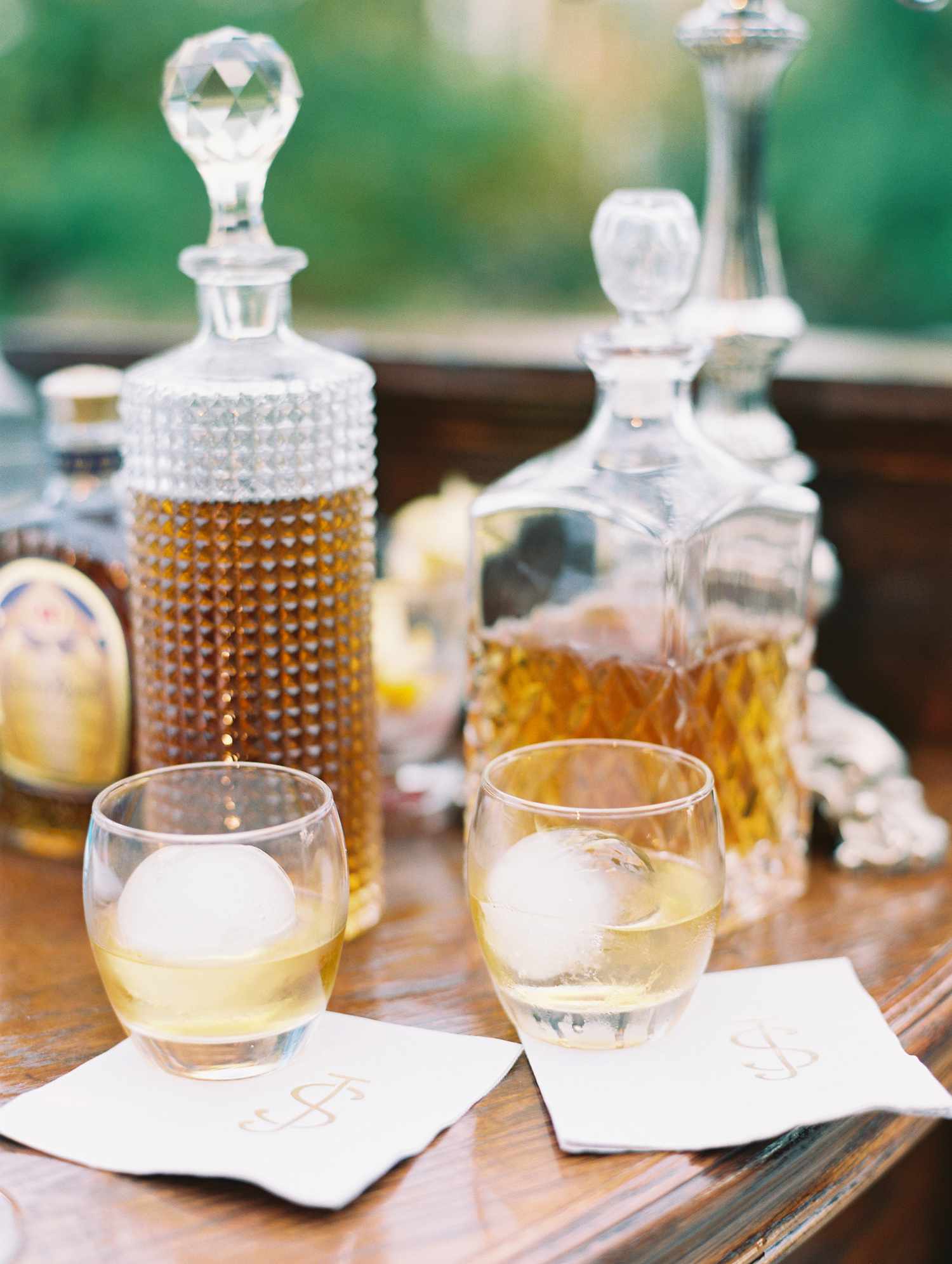 Two crystal decanters on a bar