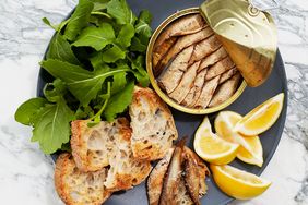 tinned fish with toasts, arugula, and lemon