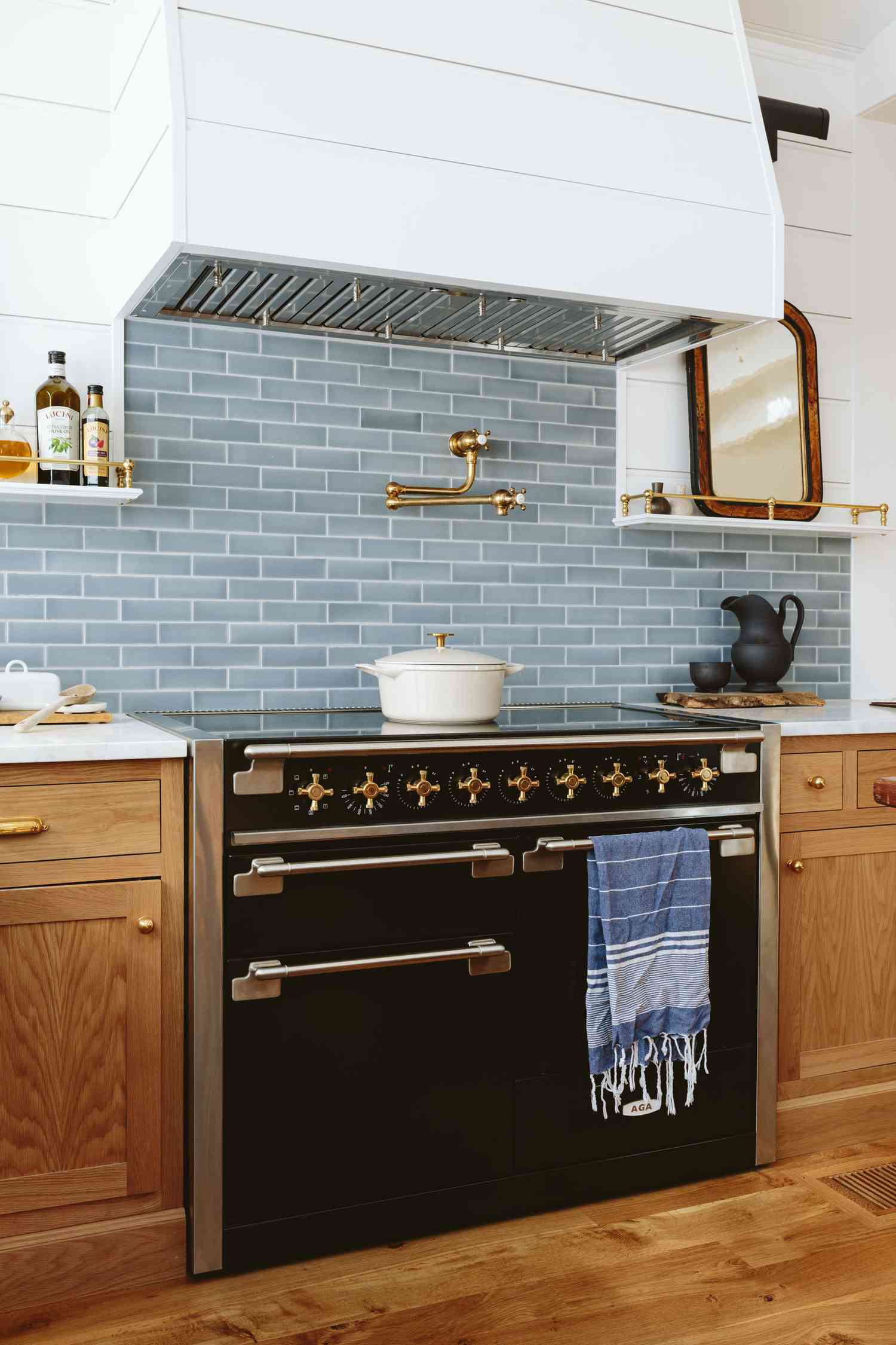 Modern kitchen with induction stovetop and blue backsplash
