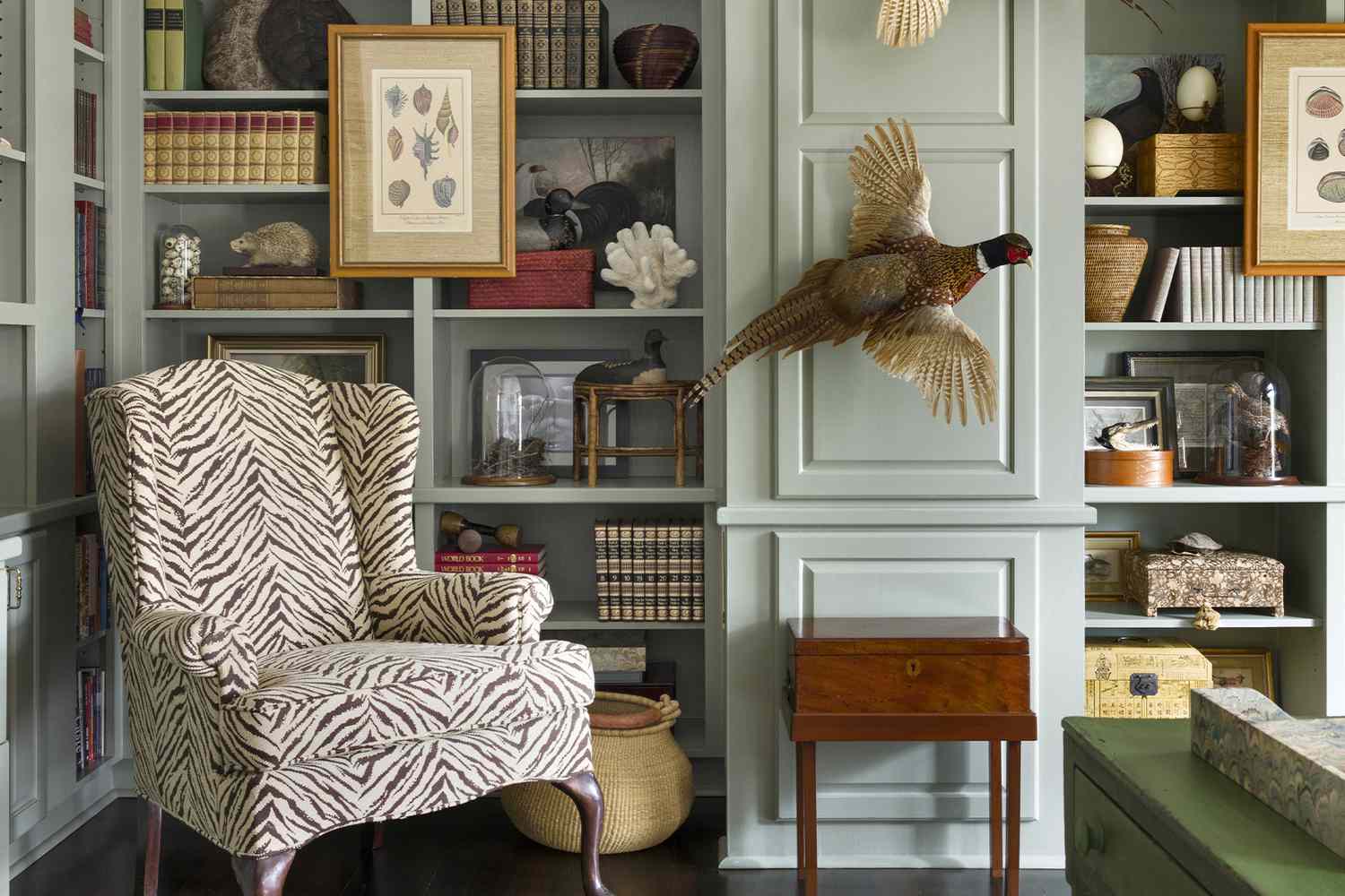library shelving with print chair and pheasant