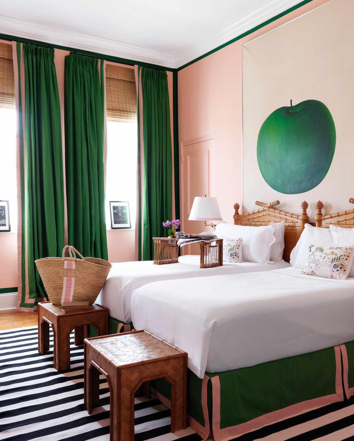 pink and green bedroom with giant apple painting