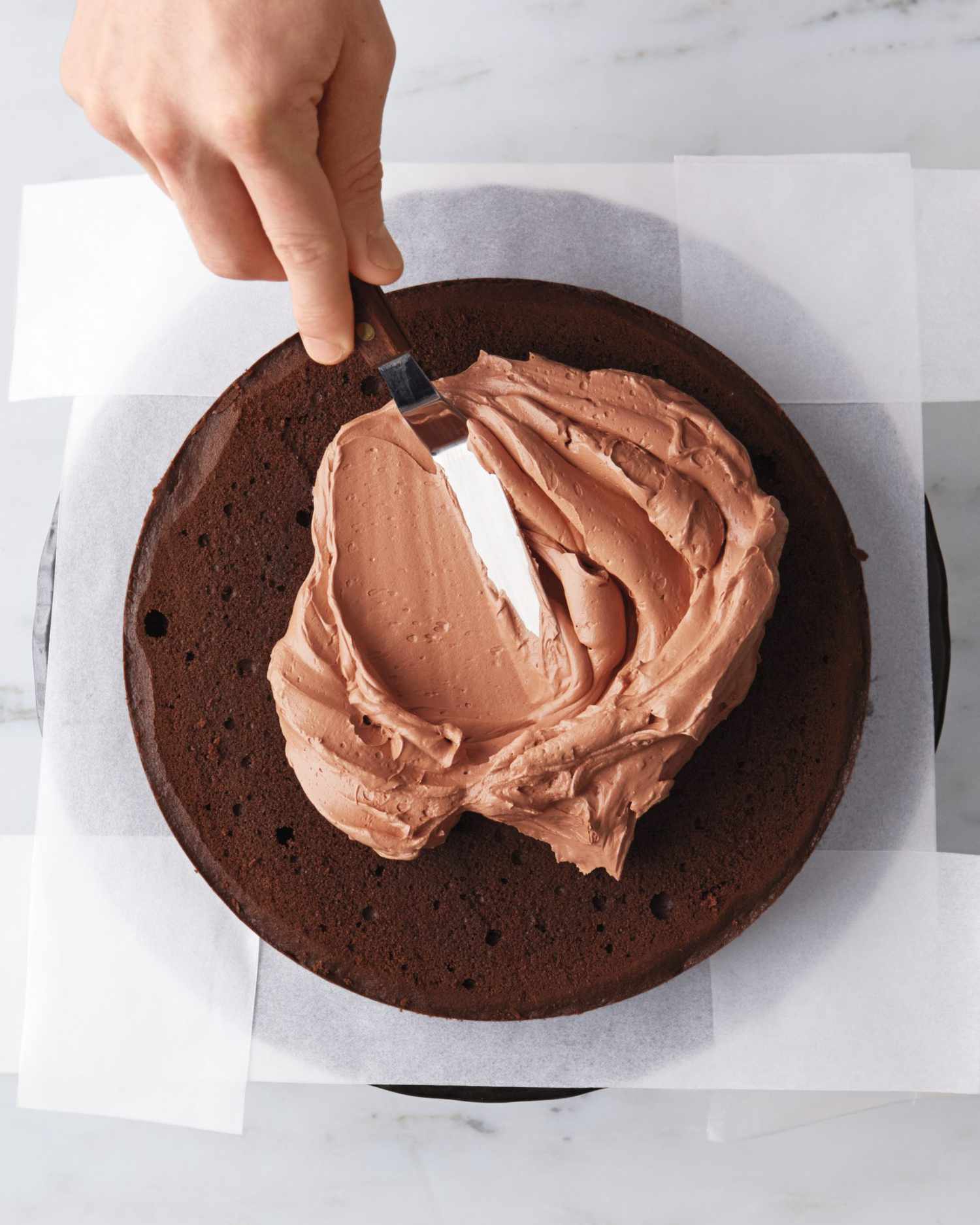 spreading frosting between cake layers