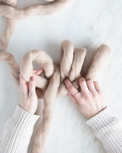 hands creating row of loops for arm knit blanket