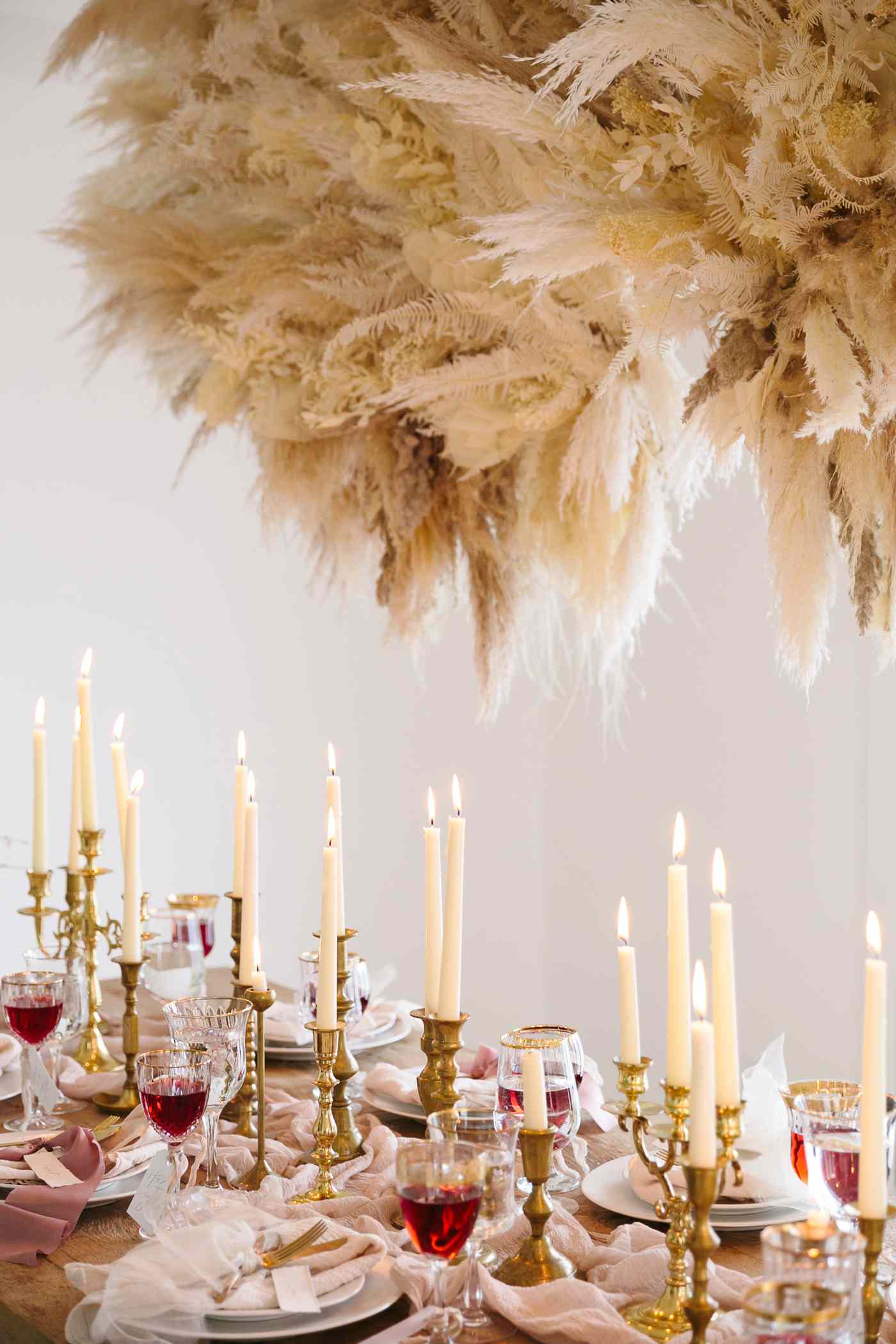 romeo and juliet valentines day party table setting with gold candle sticks and glasses of wine