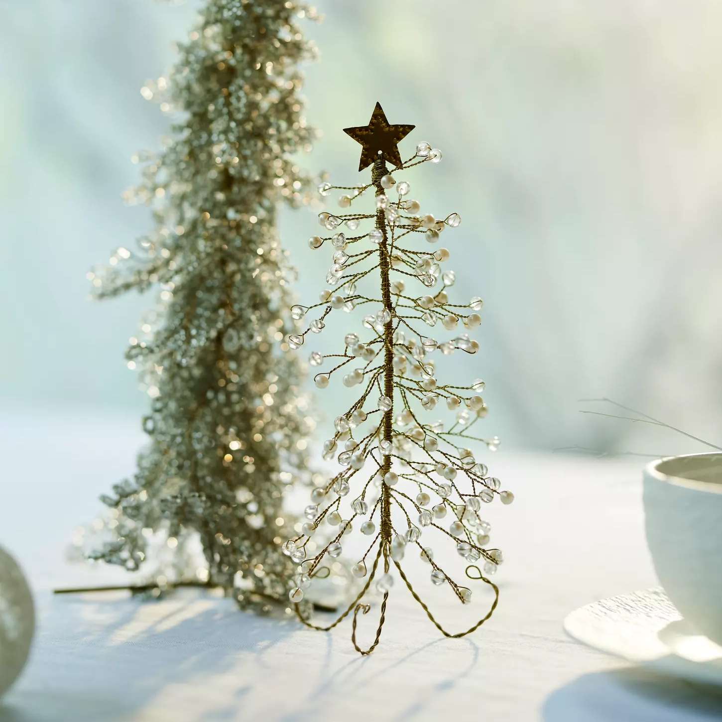 Decorative bead tree with star top on table