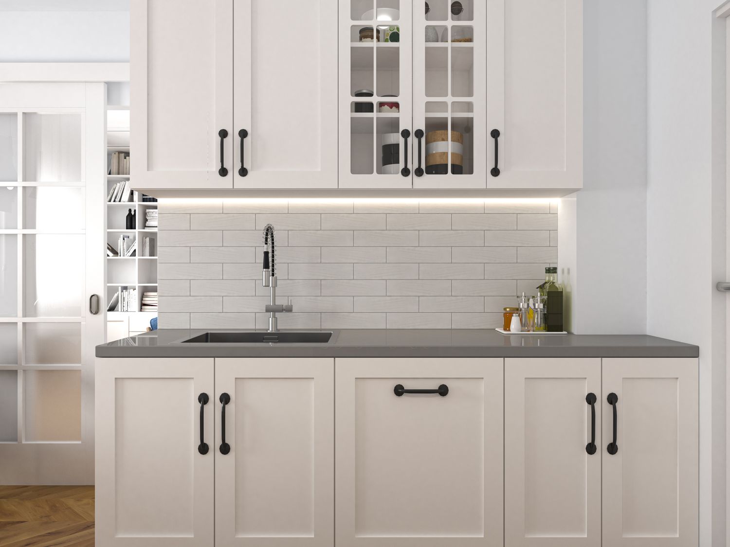A modern kitchen interior featuring cabinets a backsplash and a sink