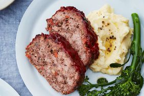 two plates of meatloaf potatoes and broccolini
