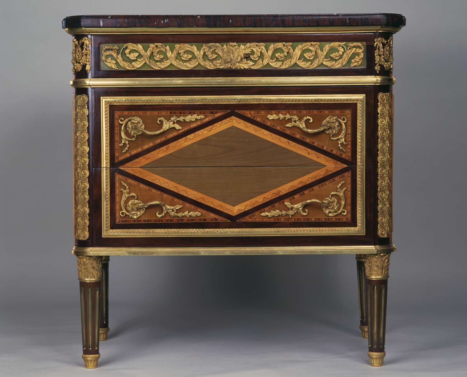 Antiquestyle wooden chest with ornate gold details and a diamondshaped inlay on the front