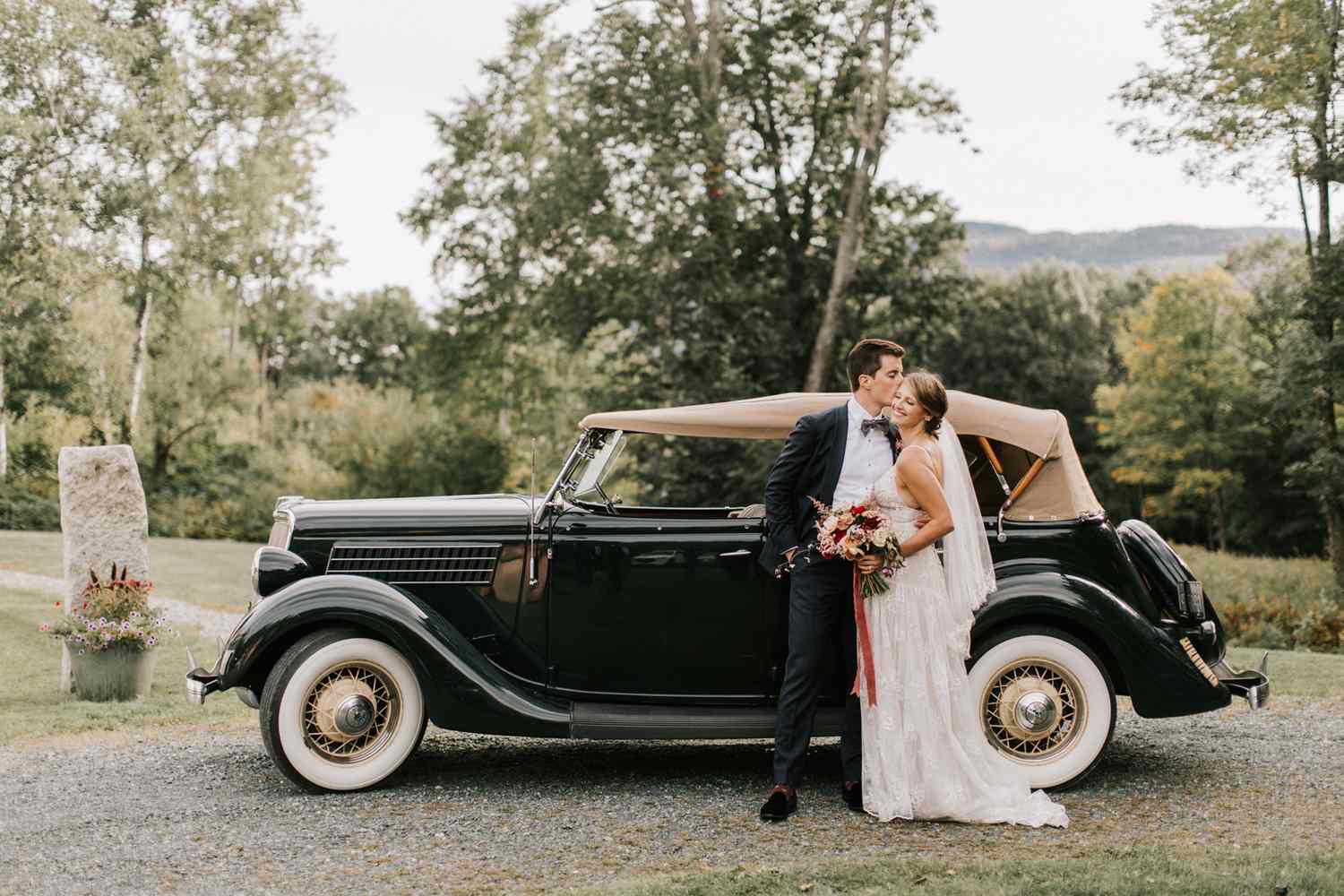 bride and groom standing next to 1936 Model A Ford vintage car