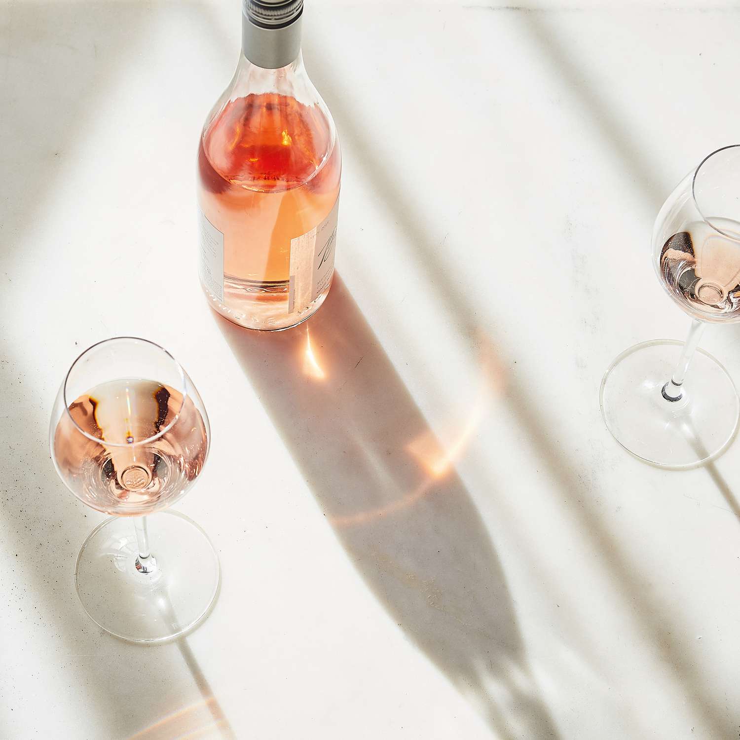 rose wine bottle and glass on table