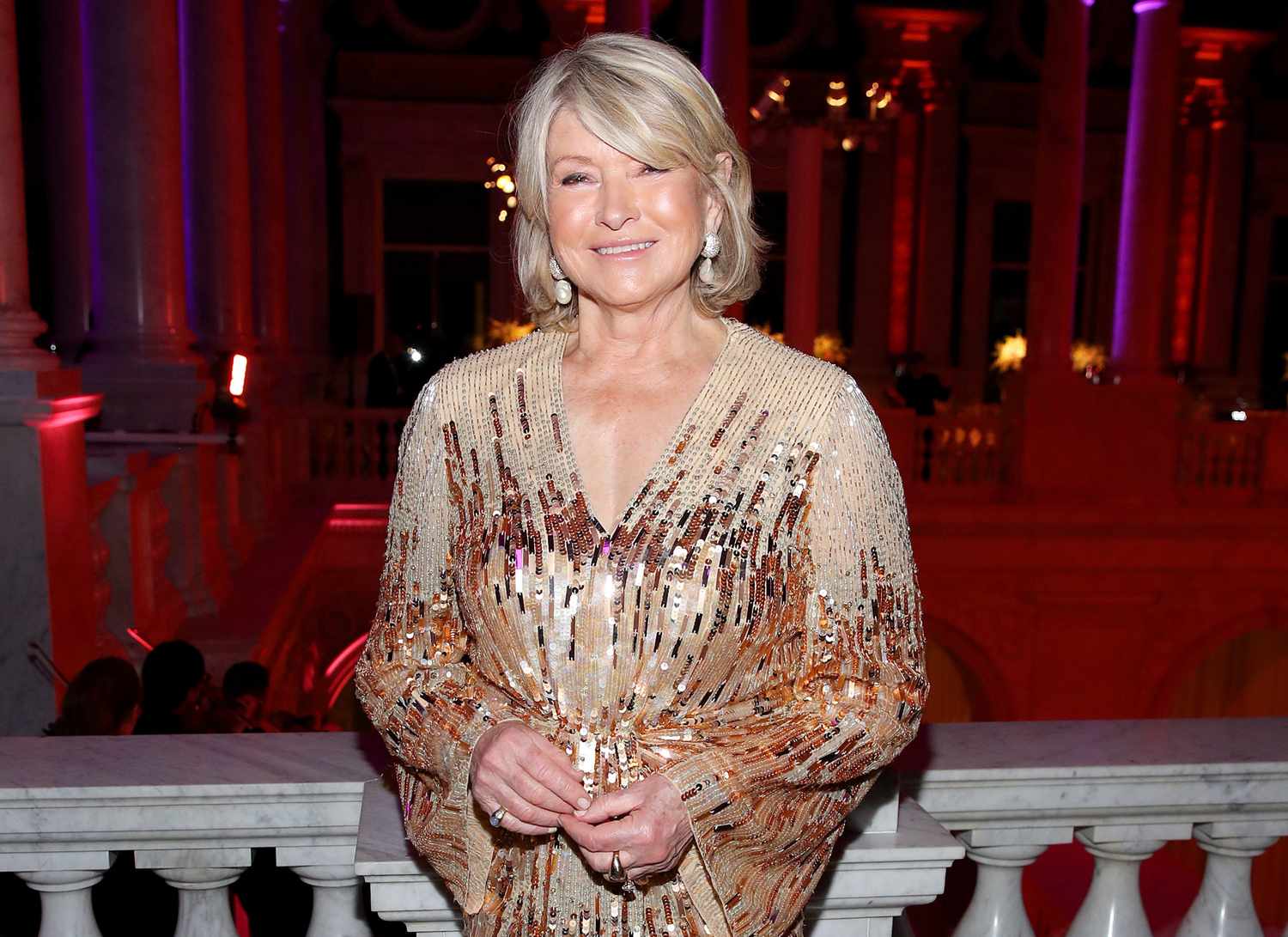 decorvow dressed in a gown, standing at an event