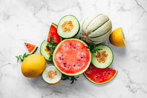 honeydew and watermelon fruits on marble surface