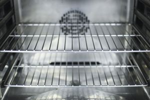 Interior of an oven with multiple metal racks visible