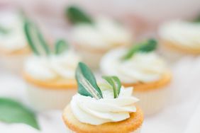 vanilla cupcakes with white frosting and green leaves