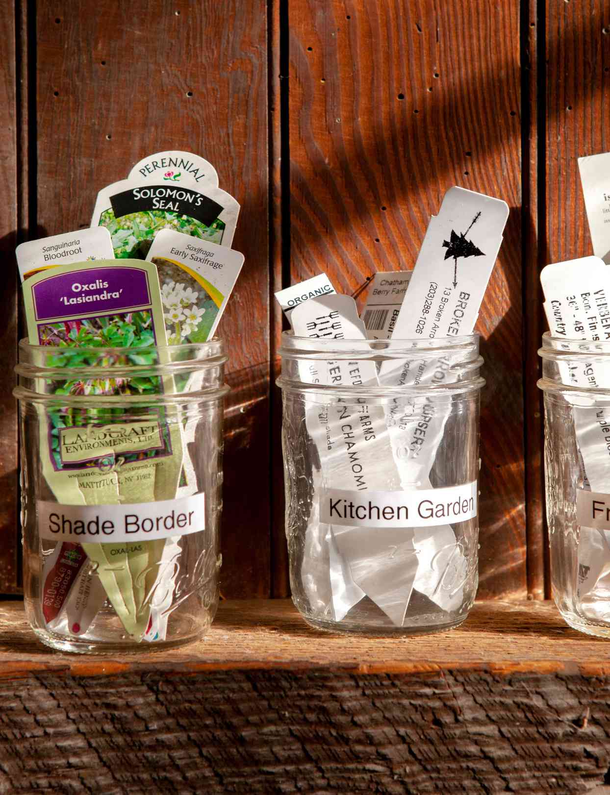 plant markers in glass jars on shelf