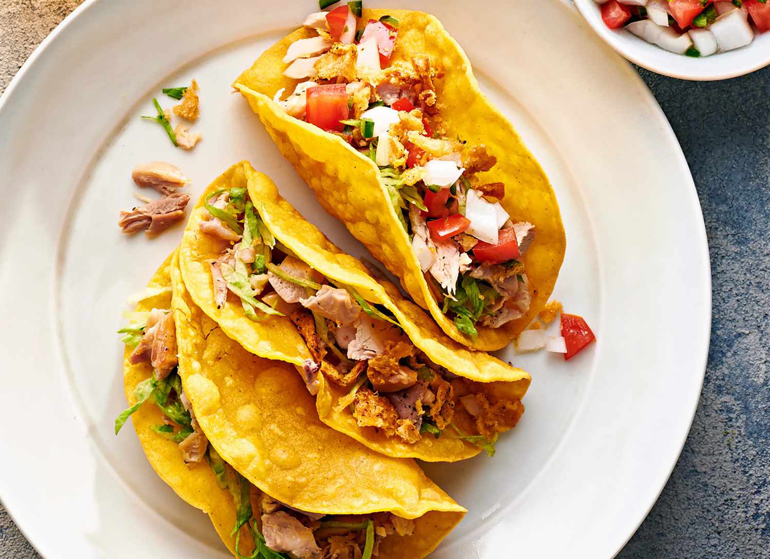 overhead view of crispy chicken tacos on a plate