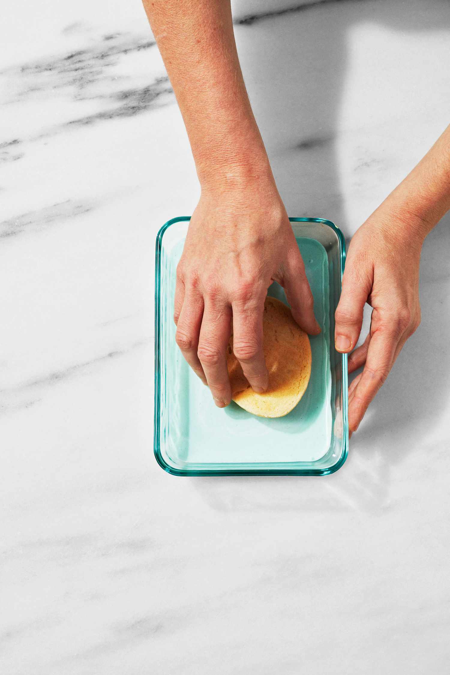 martha dipping cookie face down in frosting