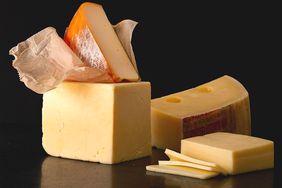 multiple cheeses on a dark background