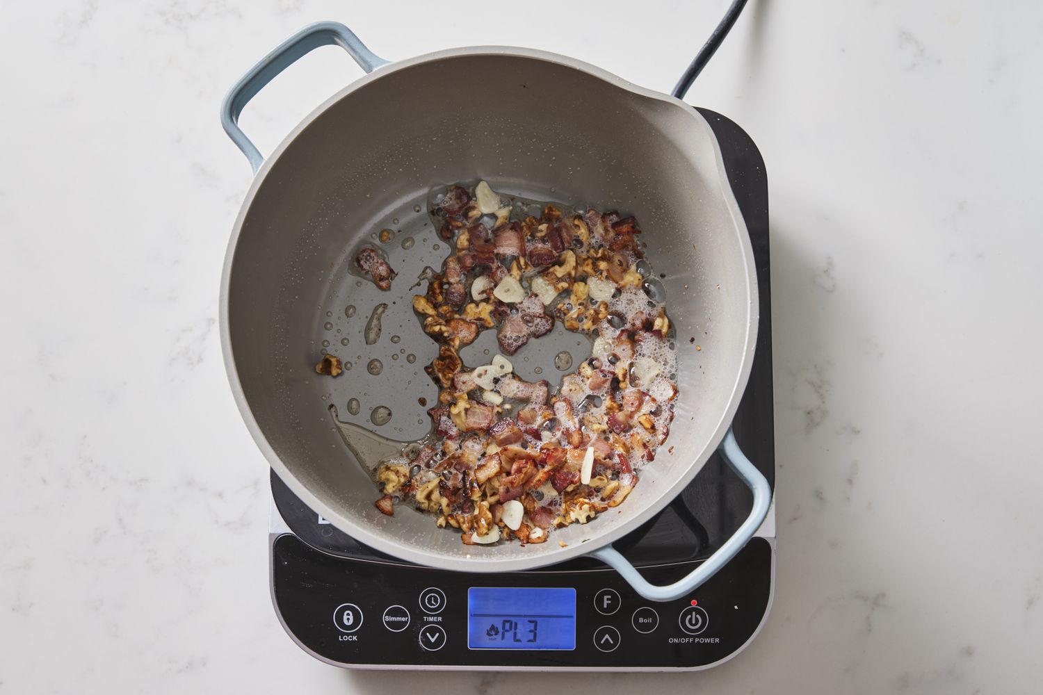Garlic, bacon in skillet