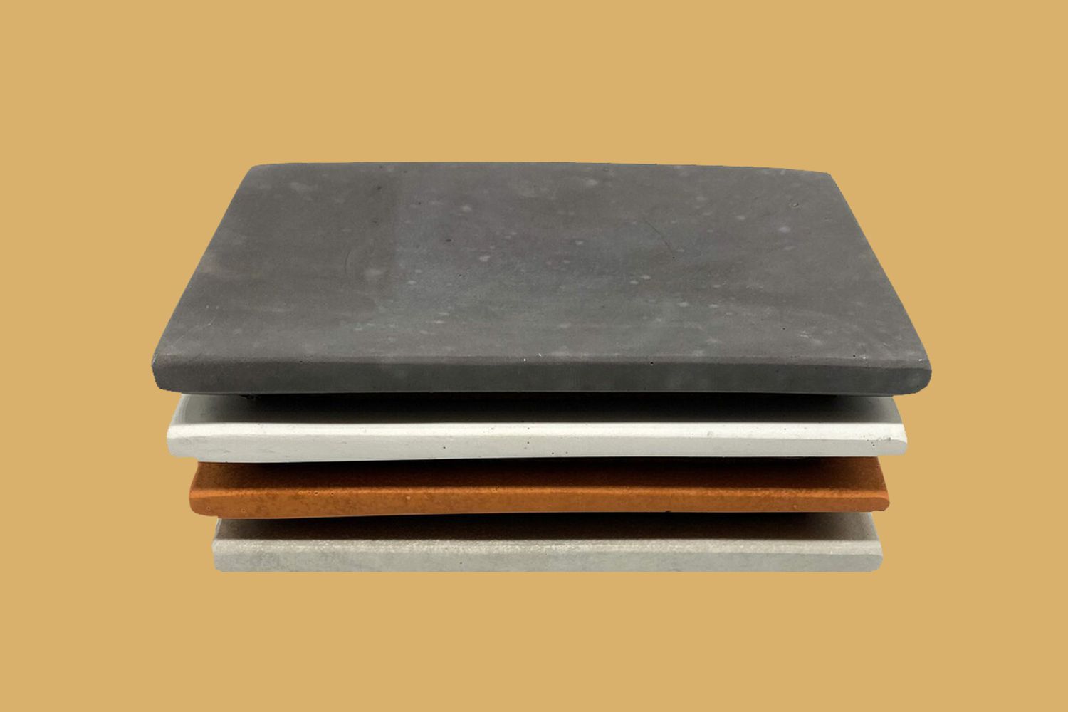 stack of concrete ring dishes on yellow background