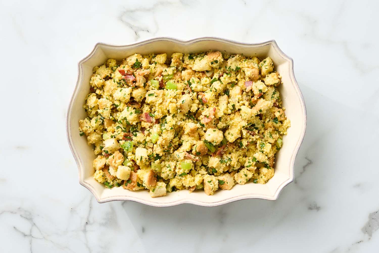 Dish of bacon cornbread stuffing in a decorative baking dish
