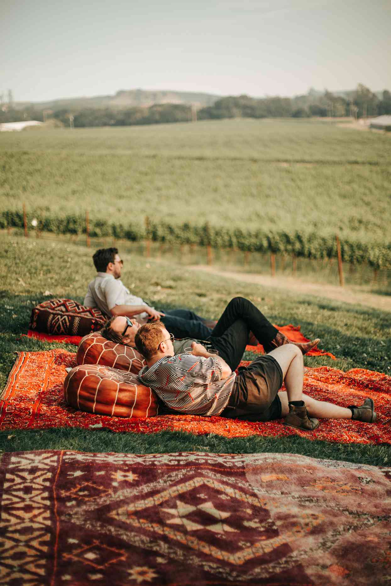 austin alex wedding guests lounging on Moroccan rugs