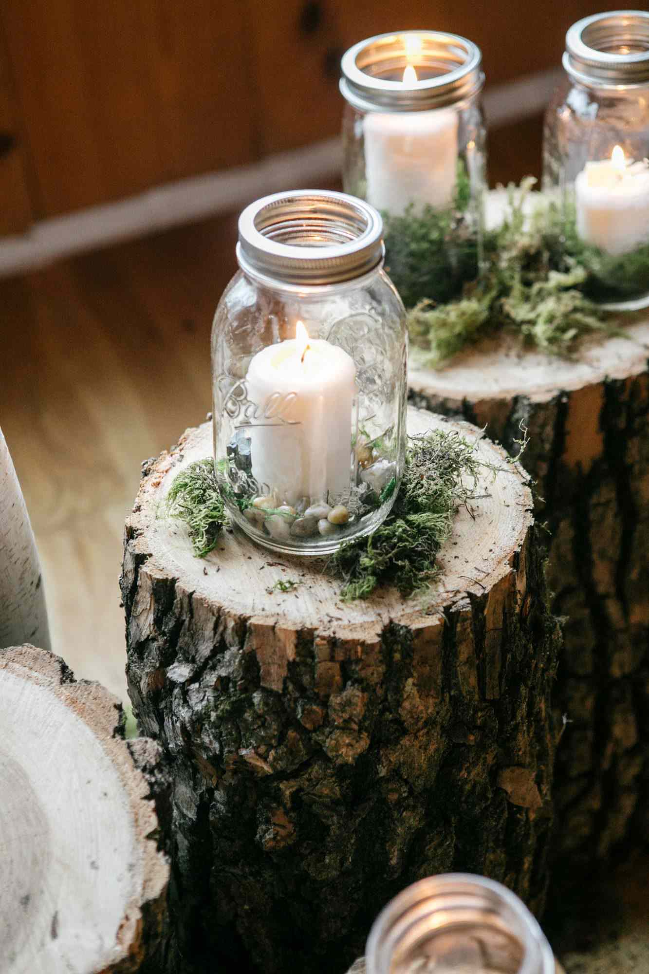 mason jar candle holder over tree stumps