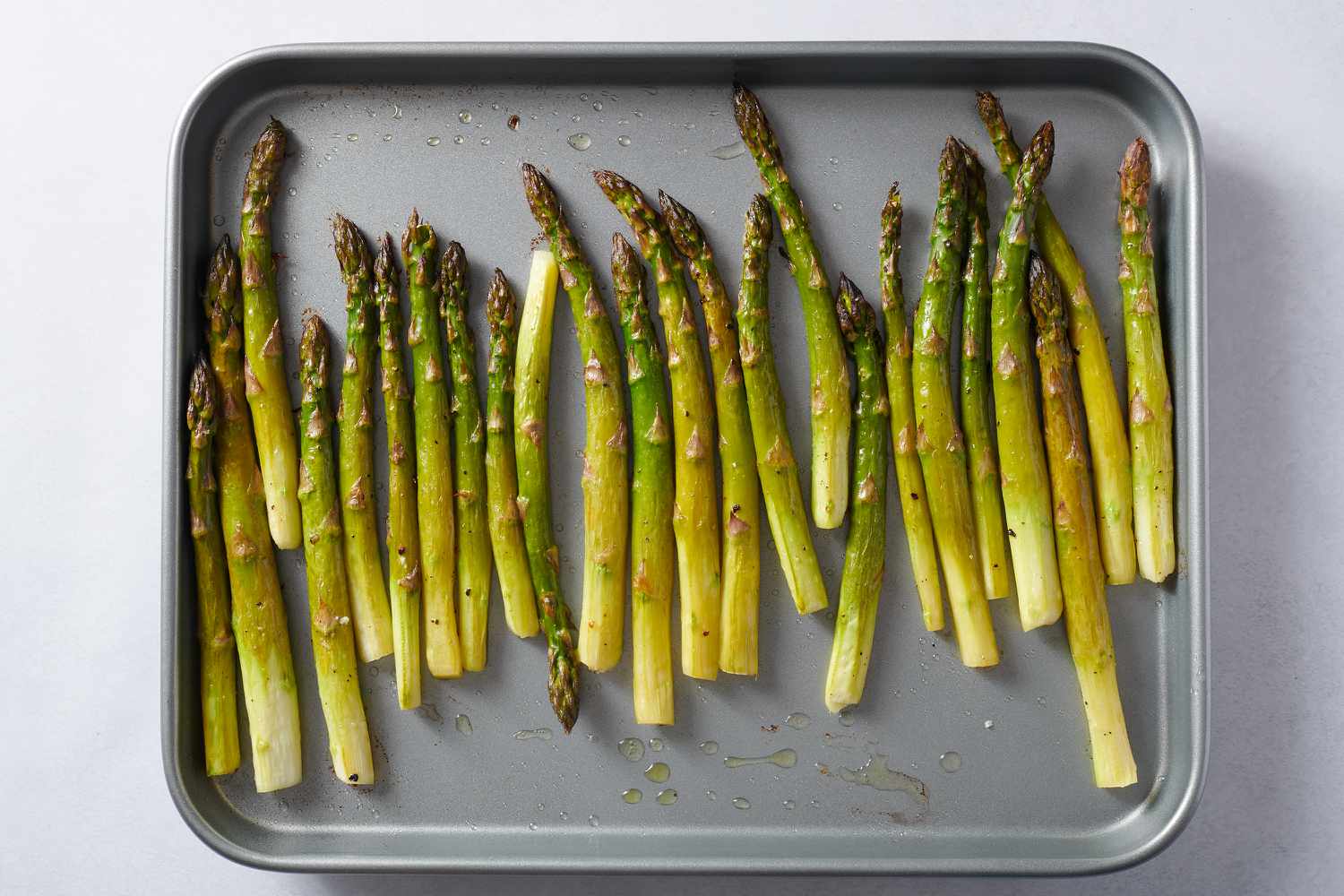 roasted asparagus on baking sheet