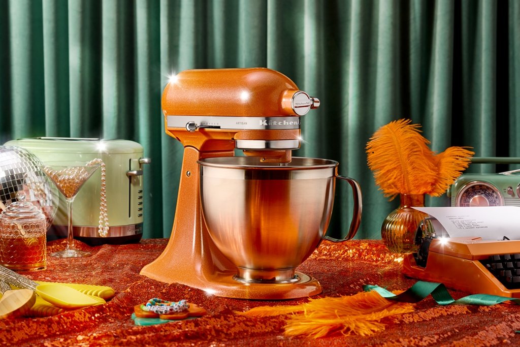 Stand mixer displayed on a countertop with retroinspired decor around it