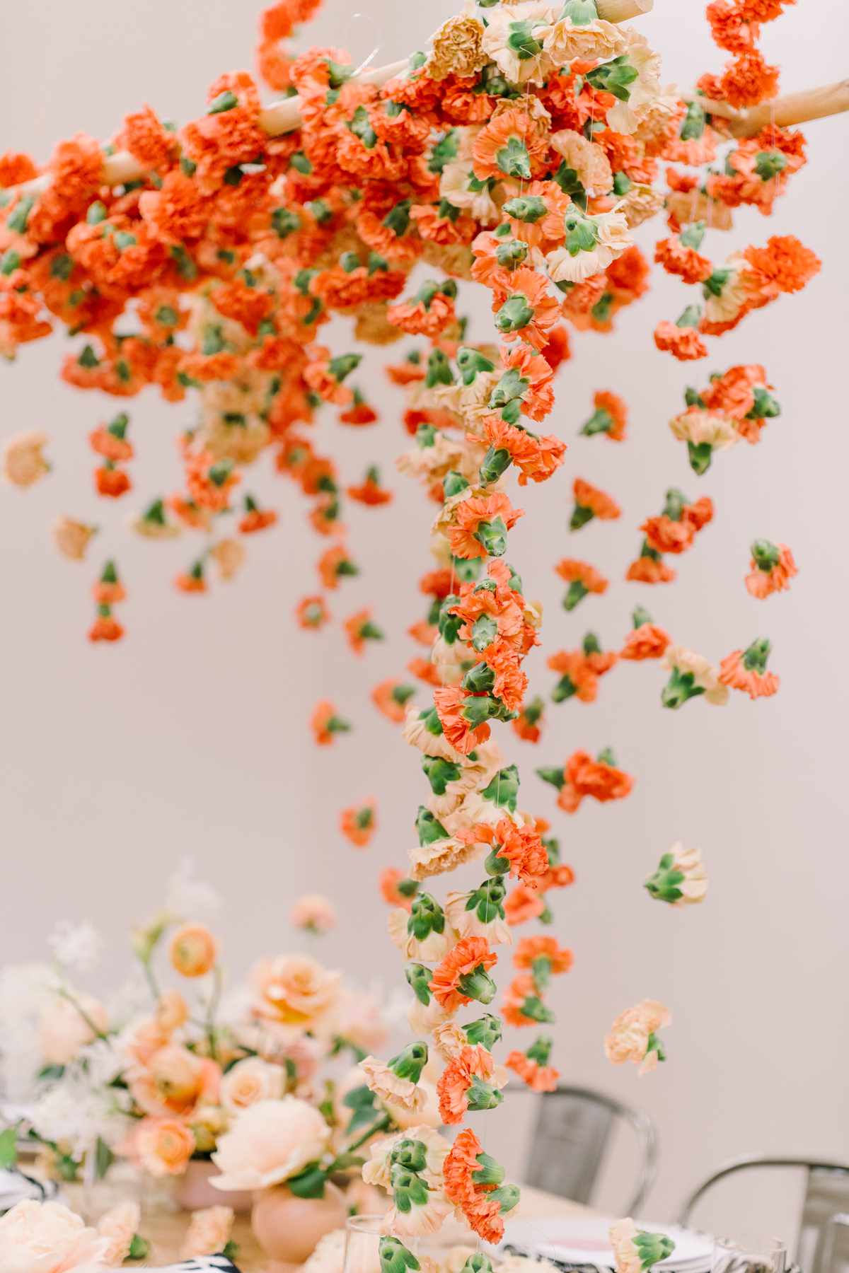 orange carnations suspended above table