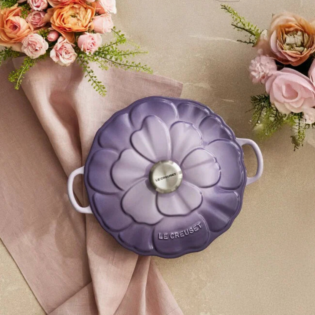 Le Creuset flowershaped casserole dish on a decorative table setting with flowers