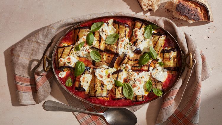 eggplant involtini with fresh tomato sauce topped with fresh basil leaves
