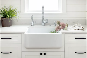 White sink with pink flowers in it 