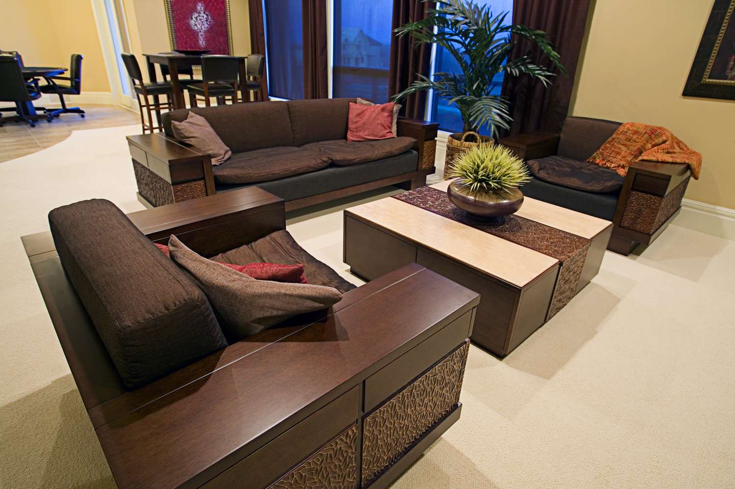A modern living room setup with wooden furniture a coffee table and floor plants