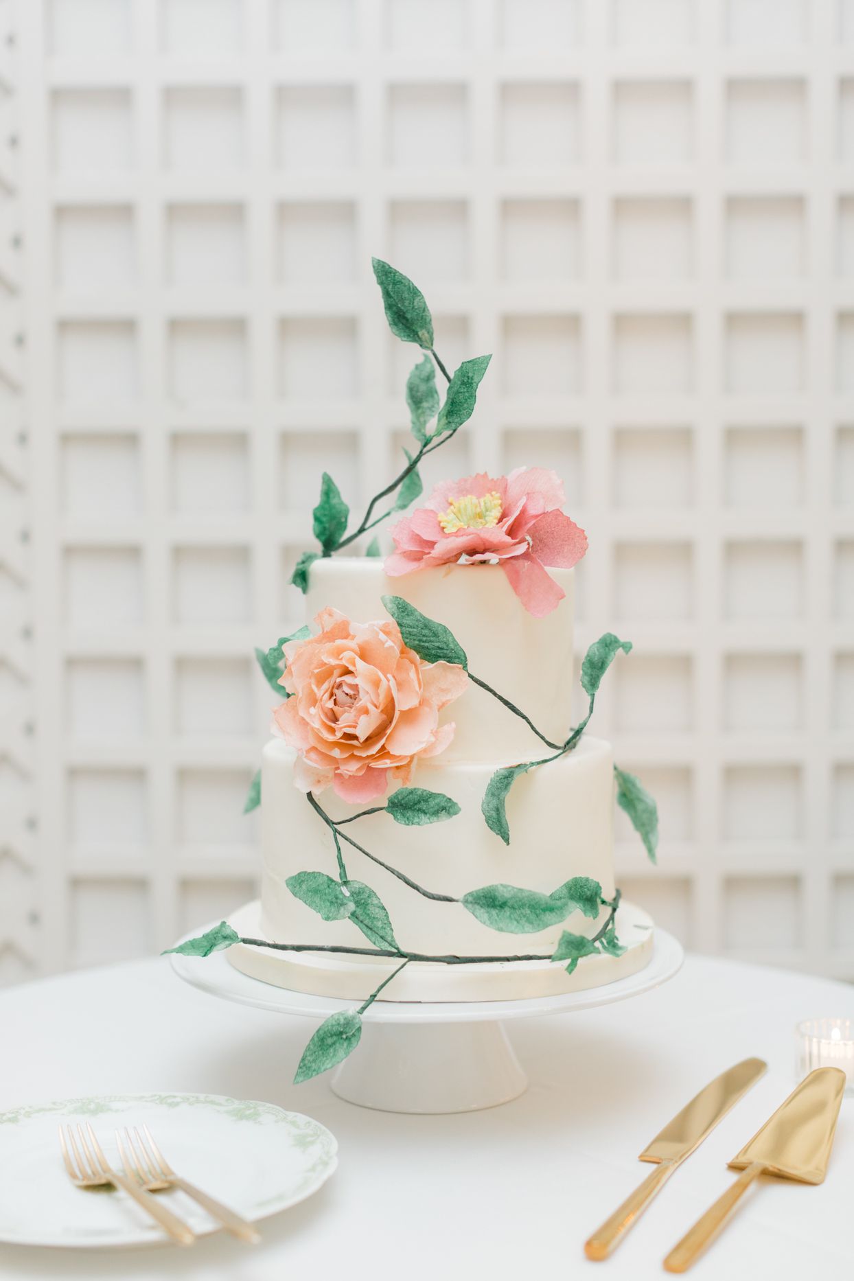 elegant white wedding cake with peach and coral flowers