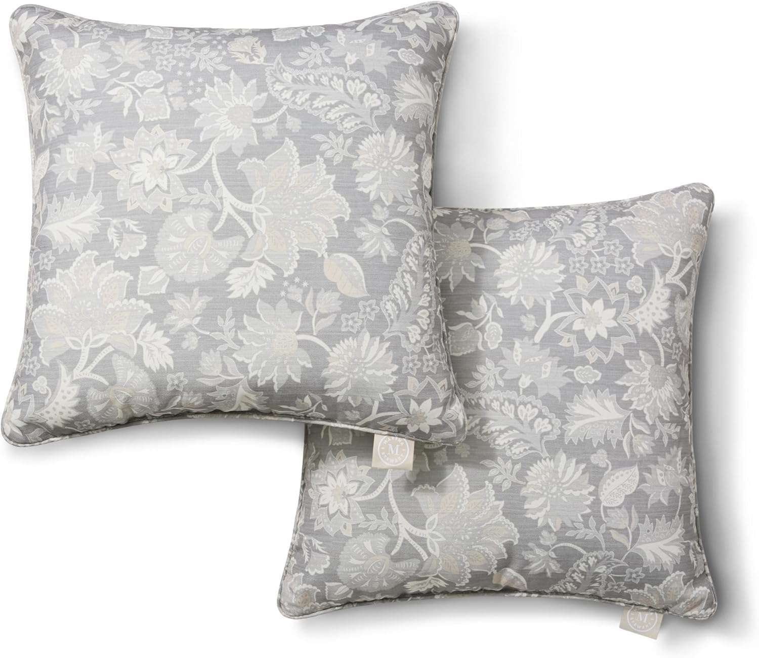 Two decorative throw pillows with a floral pattern arranged in an overlapping manner